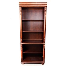 Oak Bookshelf: A solid wood bookshelf made of oak. This beautiful piece features two tiers, five shelves with ornate leaf carvings to the sides and rests on short bun feet.