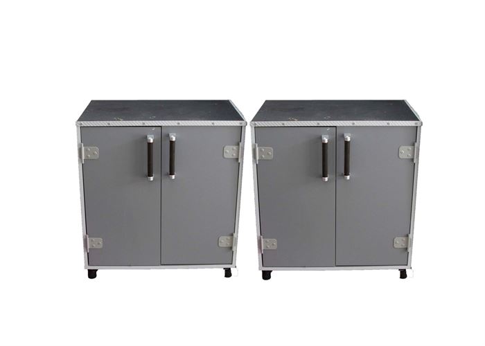 A Pair of Sauder Short Storage Cabinets: A pair of Sauder short storage cabinets. These cabinets feature manufactured wood frames with dark gray laminate finish, silver tone door pulls with black grips, interior shelving, and a black textured top cover. Companions to items # 002, #003, #004, #005.