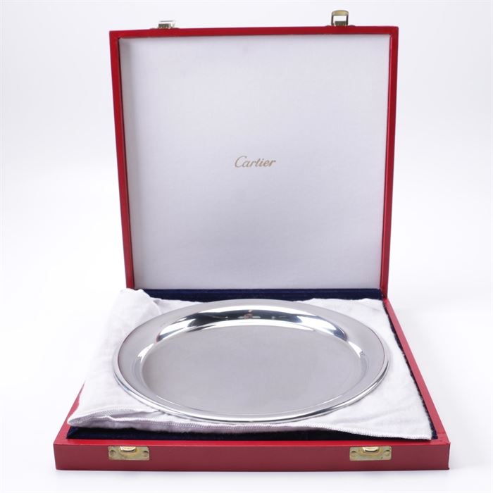 Cartier Pewter Plate: A pewter plate by Cartier. This plate feature a round body. The plate comes in a red storage case with latch closures.