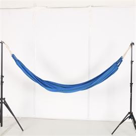 Blue and Green Striped Hammock: A blue and green striped hammock. This hammock is primarily blue with green stripes. It has white cords wound through braided ropes affixed to the ends, and comes with two carabiners. The camera tripods are not included.