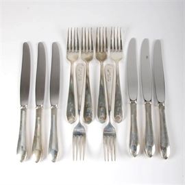 S. Kirk & Son Monogrammed Sterling Silver Flatware: A grouping of S. Kirk & Son sterling silver flatware pieces. This grouping offers twelve pieces, including six forks and six dinner knives. The pieces are monogrammed with “CJG” to the handles and each are dated 1983 through 1988. The dinner knives feature stainless steel blades and all pieces are marked appropriately. The total approximate weight of forks is 10.02 ozt. The knives were not weighed due to stainless elements.