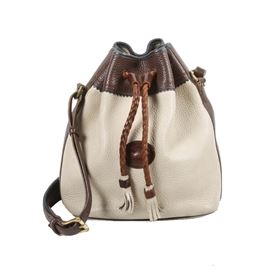 Dooney & Bourke Leather Drawstring Handbag: A tan and white Dooney & Bourke leather drawstring handbag. The bag has a bucket style, with a leather drawstring top. The interior is lined in light colored suede, and it is labeled “Dooney & Bourke, Inc. Made in U.S.A.” The serial number is A4852410.