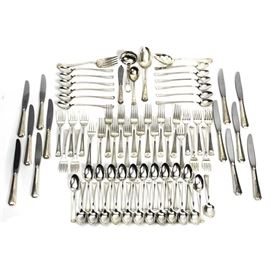 Monogrammed Gorham Sterling Silver Flatware Set: A set of monogrammed Gorham sterling silver flatware. The set is engraved with the monogram “VSA”, and includes twelve each, iced tea spoons, salad forks, dinner forks and dinner knives. Also included are twenty-four teaspoons, one large spoon, one ladle, one soup spoon, one slotted spoon, one serving spoon and one small knife. The handles of all are marked “Gorham Sterling”, and the blades of the knives are marked “Stainless Blade – Gorham Sterling Handle”. The set comes in a wooden flatware storage box with brown felt lining marked “Reed & Barton Tarnish Preventive Cloth”. The lid of the box has a monogrammed oval with “VSA” on it. Total approximate weight of the flatware, excluding the knives with the stainless blades, 82.940 ozt.