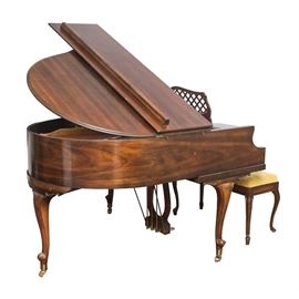 Kimball Baby Grand Piano: A Kimball Baby Grand Piano. This wood encased piano has a warm brown wood stain. The piano legs have casters on the bottoms of the feet. It is marked “52 Keys, 1911, Approved July 3, 1926, Made by Kimball Piano & Organ Co, French Lick, Ind, Lic No. N.Y. 38870.”. The inside workings of the piano are marked “W. W. Kimball Co. Chicago, U.S.A., 1857”. Also included is a wooden framed piano bench with a hinged lid. The piano stool has a yellow velvet, box tufted seat. Within the seat are various pieces of piano music and a tag marked “Kimball Piano & Organ”.