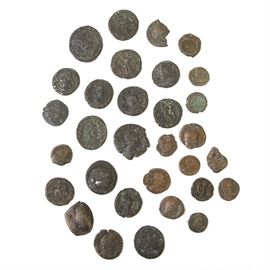 Roman Bronze Coin Collection: A Roman bronze coin collection. Included in this collection are numerous antique currency coins from Rome. The faces of the coins depict people and the reverses have various symbols. These coins are very worn with irregular edges and finishes.
