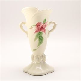 Hull Pottery "Woodland" Amphora Vase With Flower Design: A white glazed amphora vase in the Woodland style with a floral design by Hull Pottery. It has a tapered body with pink and blue flowers with a vine design with two handles. It has a flared base. It is marked to the underside.