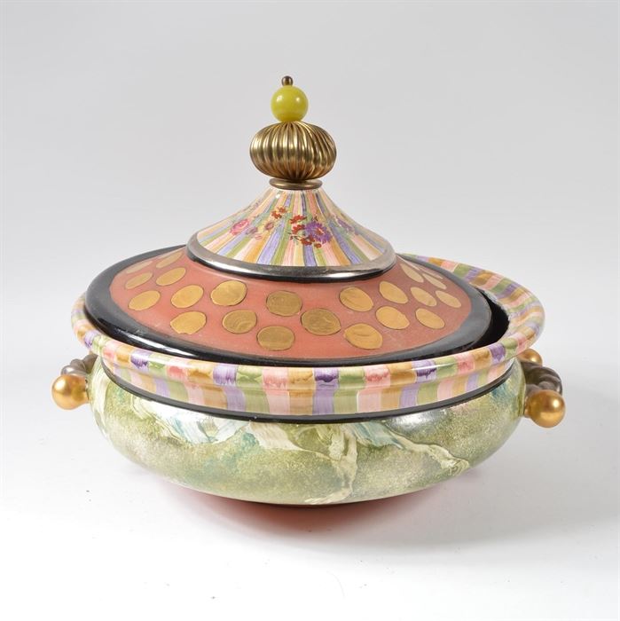 MacKenzie-Childs "Torquay Frank" Hand Painted Tureen: A hand-painted ceramic Torquay Frank tureen from MacKenzie-Childs. The basin is painted with a variety of colors, including a red clay-like matte paint, gold-tone foil paint, and an olive green paint in a marbled pattern. The piece has two handles painted with metallic tones and a metal and stone topper.