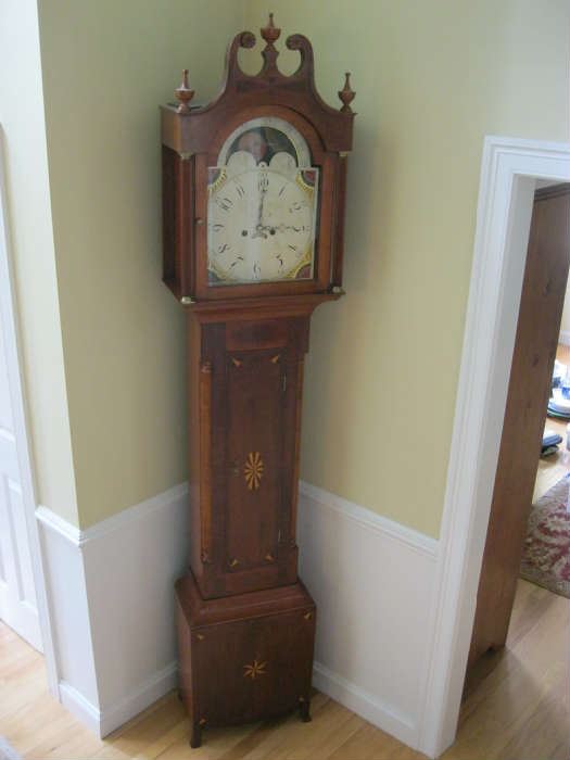Inlaid mahogany case tall clock of Central NY origin made circa 1810.  Painted dial attributed to the Boston firm of Nolan & Curtis.  Brass time & strike movement, 8' tall