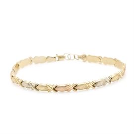 14K Tri-Gold Bracelet: A 14K tri-gold bracelet. This bracelet features an alternating pattern of “X” and “O” links with stars in yellow, rose, and green gold.