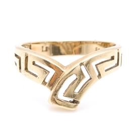14K Yellow Gold Geometric Ring: A 14K yellow gold geometric ring. This ring features a high polish “V” shaped center of a pierced geometric band.