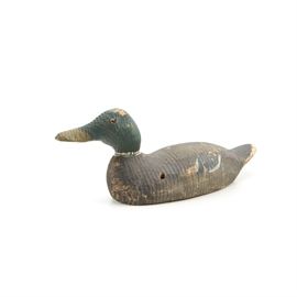 Handmade Wooden Duck Decoy: A handmade wooden duck decoy. This carved and painted wooden decoy depicts a male mallard duck, with a green head, brown and black body and orange glass eyes. This piece has no apparent maker’s marks.