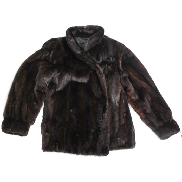 Mink Coat by Mr. J: A mink coat designed by Mr. J. This piece is made from dark brown mink fur and features hook closures and two exterior side pockets. The black lining is embroidered "Marcia D. Garvey on one side with a tag on the other side which reads “Designed by Mr. J.”