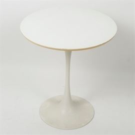 Mid-Century Modern Tulip Side Table: A vintage mid-century modern tulip side table. This round side table is constructed of wood and features a simplistic flat-white coloring. This piece has no visible markings.