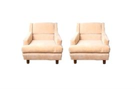 Pair of Mid Century Club Chairs by Fairfield: A pair of Mid Century club chairs by Fairfield. These streamline chairs feature wood frames, with tapered peg legs and are covered in a soft, velvet-like peach upholstery. The original manufacturer tags are located under the seat cushions.