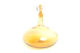 1967 Joel Myers Blenko Decanter: A 1967 Blenko art glass decanter by Joel Myers (active at Blenko from 1963-1970). This work has been created from an amber colored glass, and topped with a ball stopper with interior swirl accents.