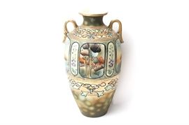 Art Nouveau Period Chinese Vase: An Art Nouveau period Chinese double handled vase. This finely detailed work features a hand painted center design of a cottage with lotus blossoms, matte glaze accents and, moriage style raised gilt beading. This unsigned work has been rendered in soothing palette of lavender, cream, peach, green, and ivory.