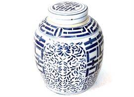 Chinoiserie Blue and White Ceramic Ginger Jar: A chinoiserie style blue and white ceramic ginger jar. The jar is in a tapered form with flat fitted lid, geometric design to the lid, jar’s shoulder and front and back. The jar has an overall foliate pattern and has protective felt to the base.