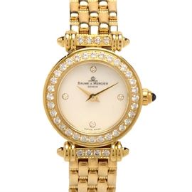 Baume & Mercier Solid 18K Yellow Gold MOP Diamond Wristwatch: A Baume & Mercier Geneve Swiss made luxury solid 18K yellow gold mother of pearl and diamond wristwatch. The watch does not come with a box or papers.