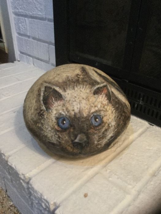 Blue-eyed cat painted on granite rock