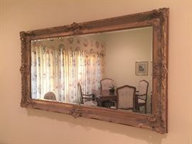 Beveled mirror in ornately carved frame