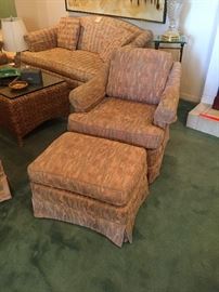 Pair of upholstered club chairs with ottomans