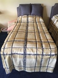 Matching twin beds with custom upholstered headboards and bedding