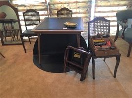 Folding card table with black vinyl top, 4 folding cane back chairs (one has damage to the caning), and an separate top to convert to a round top table