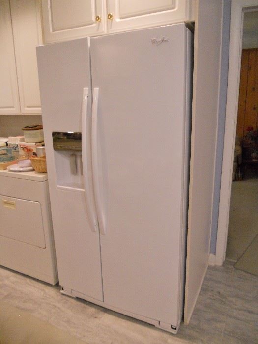 Side-by-side Whirlpool refrigerator freezer