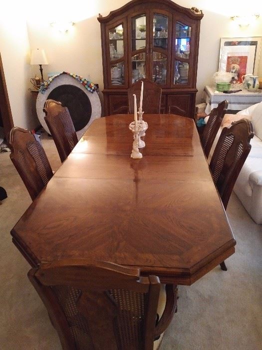 Magnificent Hardwood Dining Set.  Table has two leaves.  Includes breakfront, 4 standard chairs and two arm chairs.