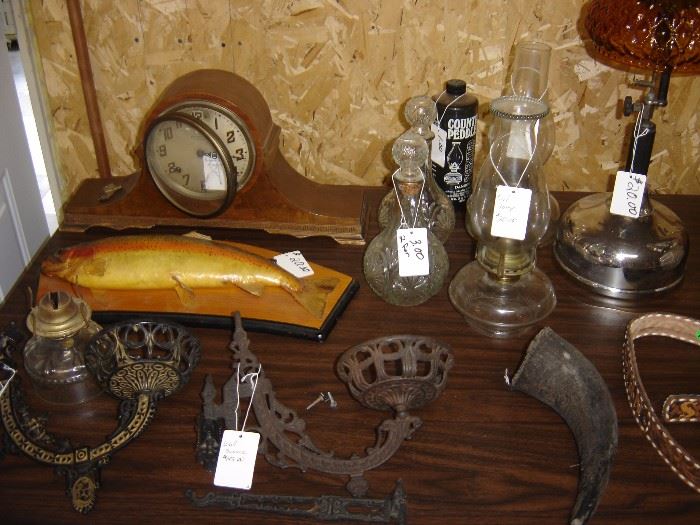oil  lamp wall sconces, mounted trout, antique clock, cow horn 