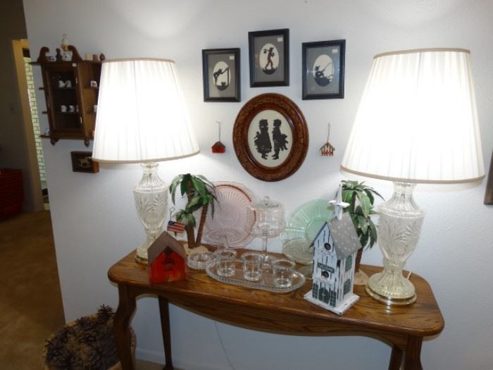 a Nice contemporary Oak sofa table w/ crystal lamps a couple of depression glass platters and candlewick glassware - on the walls more sissor cuttings