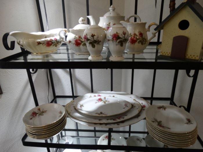 a small baker's rack w/ insert glass shelves and a large set of Moss Rose Dinnerware