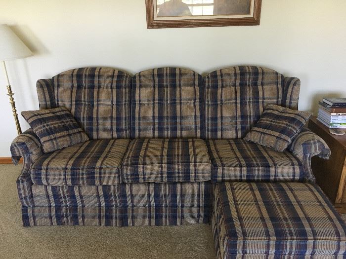 A nice sofa that has a matching love seat and ottoman.