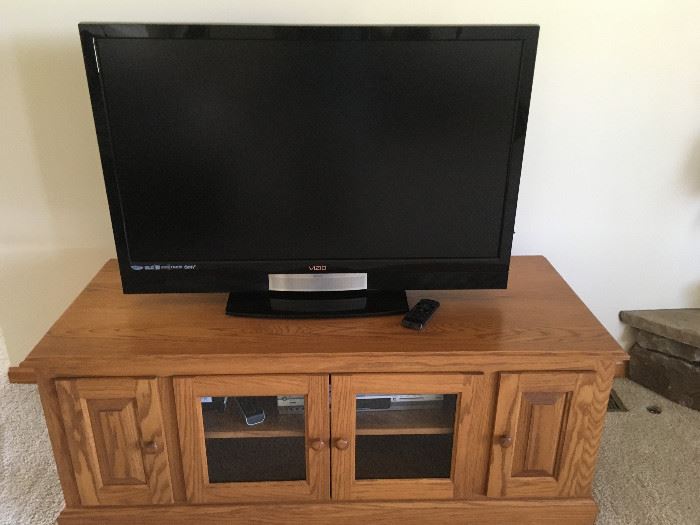 This is a 42-inch Vizio flat screen with an oak TV table.