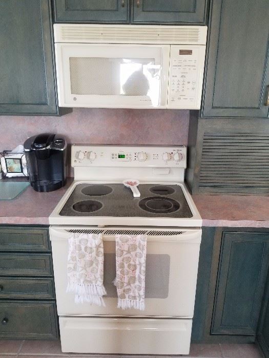 Modern electric range and GE microwave oven.