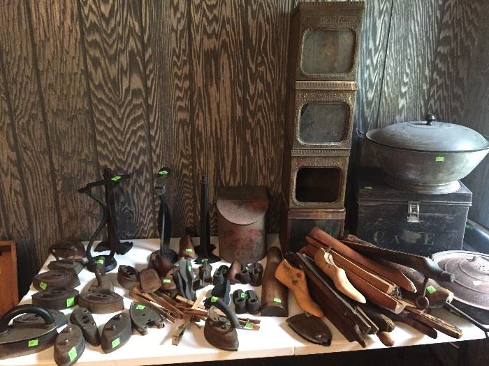 Shoe making supplies, old irons, boot forms and shoe forms, metal tins with glass fronts