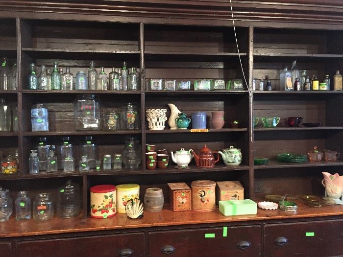 Canisters of wood, metal and glass, tea pots, old glass bottles