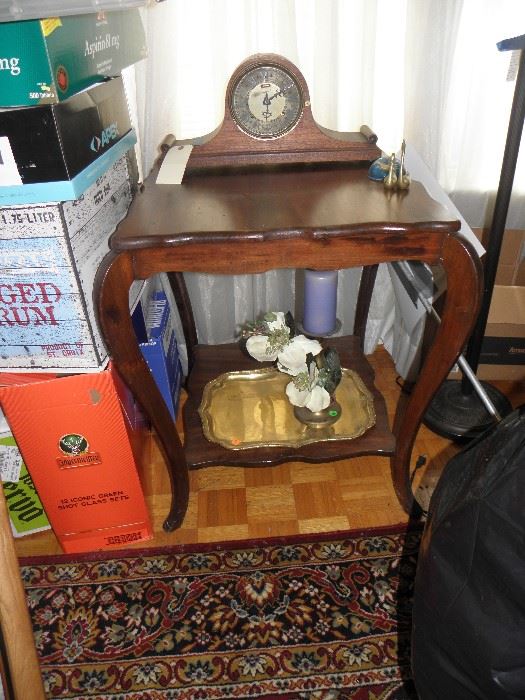 Mahogany splay leg table, Ansonia clock, brass try and candlestick
