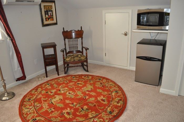Floor lamp (barely visible), two-tiered table, spindle back rocker with upholstered seat, one of several area rugs available, Frigidaire double door 3.1cf refrigerator NEW, GE Profile Sensor Convection 1.5cf microwave (SOME SOLD)
