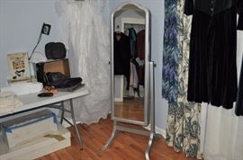 Linens, purses, shoes, wedding gown with veil and boxes, Cheval full length tall mirrored door opens to jewelry armoire, women's dresses
