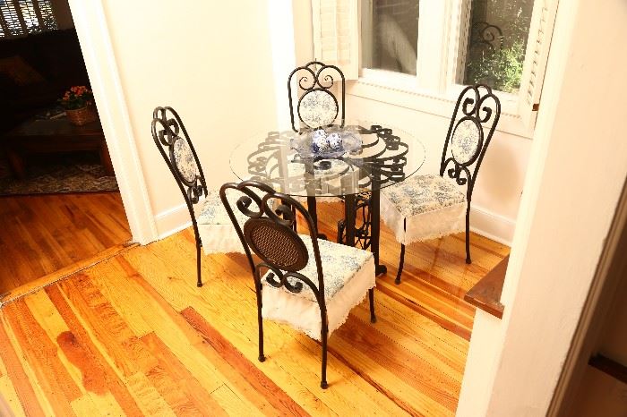 Iron and glass table with four chairs.