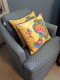 Decorative pillows; pale blue upholstered chair