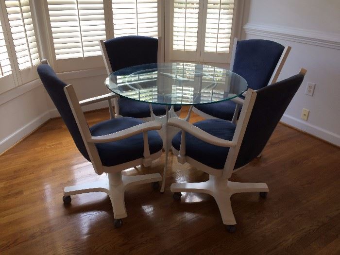 Modern kitchen table. White iron base with round glass top. 4 blue suede chairs.