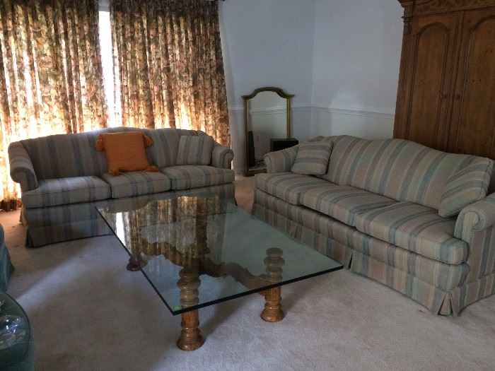 Fabulous glass top with wood base rectangular shape coffee table. Smaller couch in excellent condition as well. 