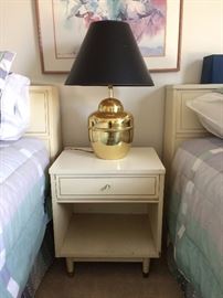 Mid Century Modern night stand. Shiny gold toned lamp with black shade.