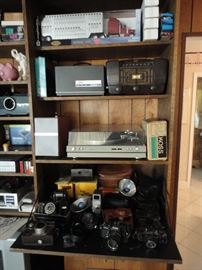 Pioneer direct drive turn table, RCA tube radio, Bozak oak speakers, Sony reel to reel, vintage stereo 8 track receiver with speakers, cameras, film projector, vintage film cameras