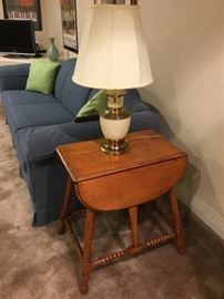 End table, lamp, couch, pillows, wall art