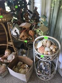 collection of seashells, bird houses, glass top and brass table