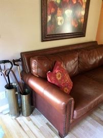 Poppy Art, leather sofa with nailhead trim, pillow, brass buckets, canes