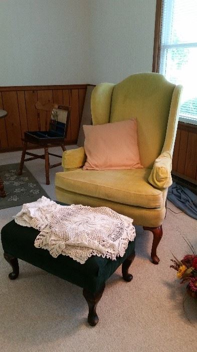 Lime green wing chair, footstool, decorative doilies